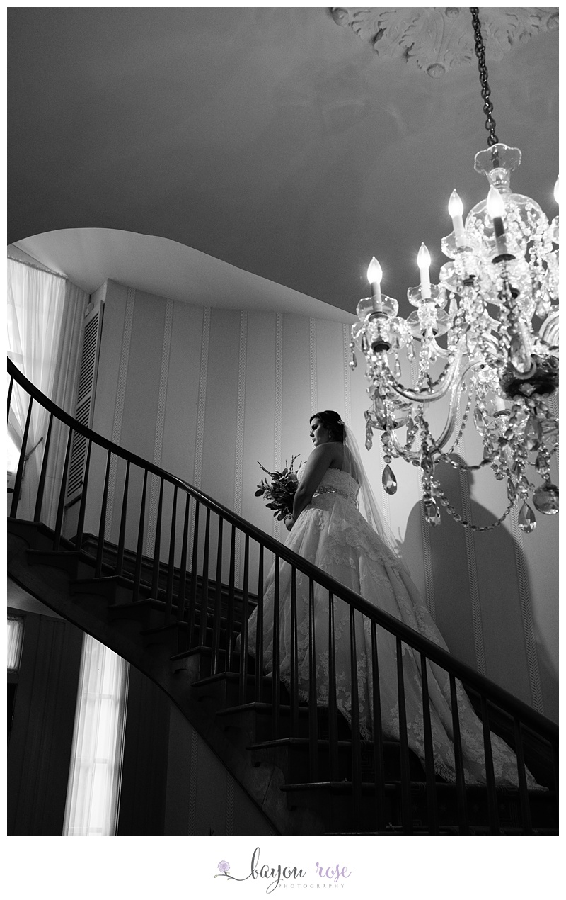 Bride on staircase with chandelier