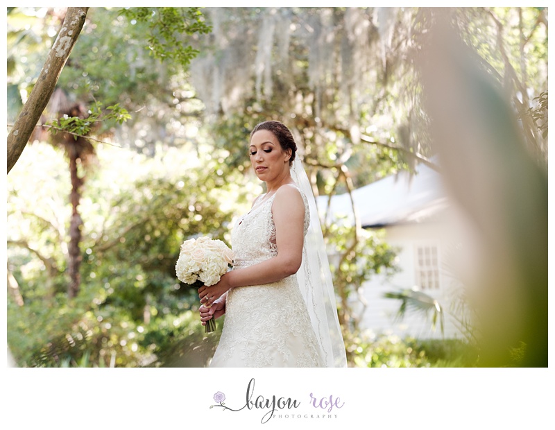 Bride against Spanish moss and greenery