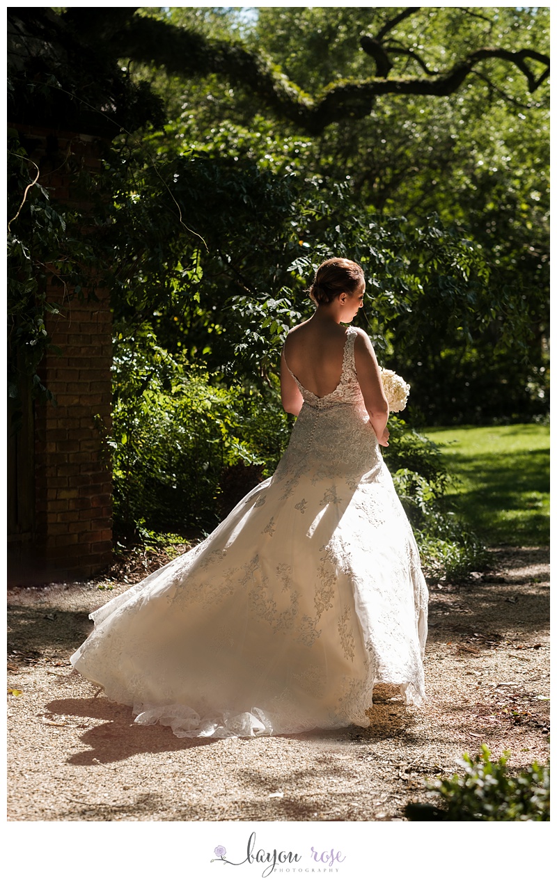 Bride in sunlight with dress blowing in wind
