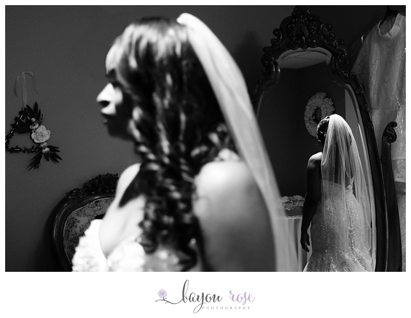 bride silhouetted in mirror in wedding dress