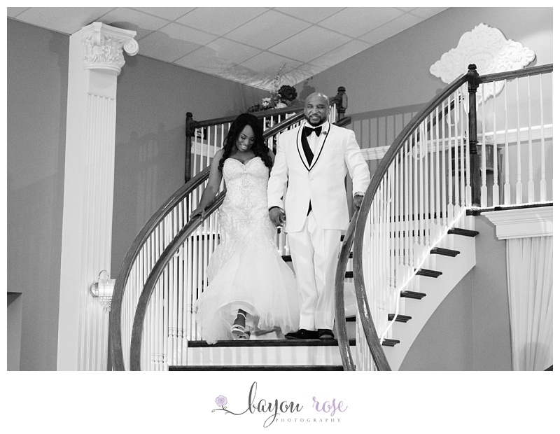 bride and groom descending staircase