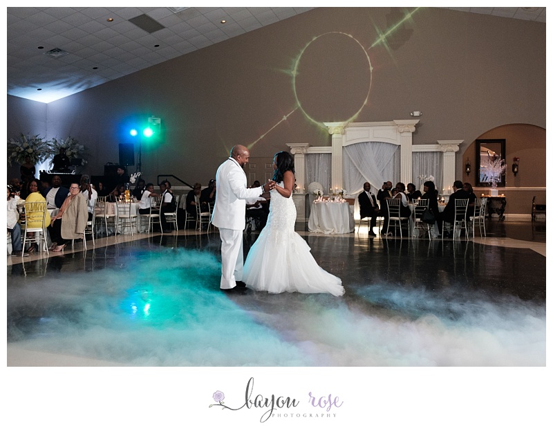 bride and groom dancing with fog