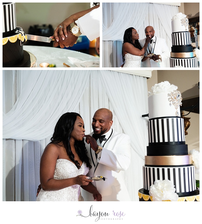 couple feeds each other cake