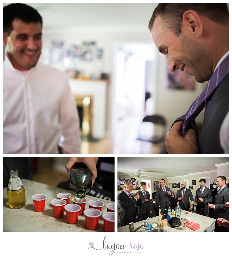 Groom fixes tie and does shots with groomsmen