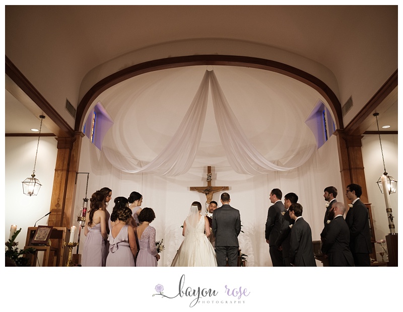 Bride and groom at altar with wedding party