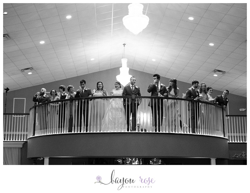 Bridal party standing on balcony