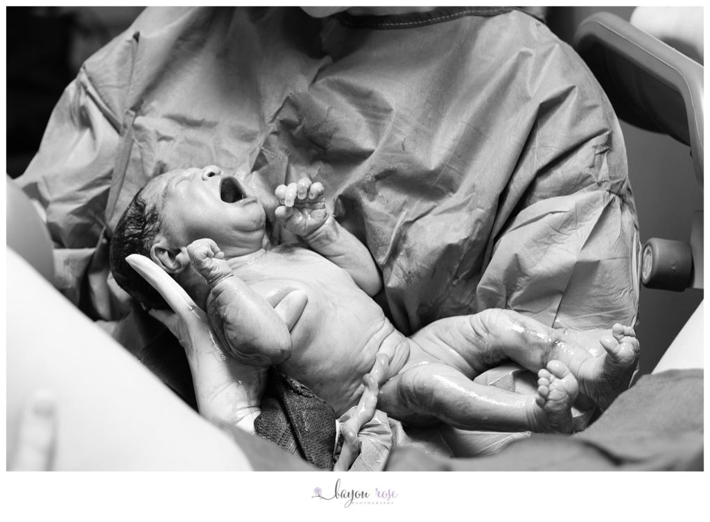 baby just after being born, with umbilical cord