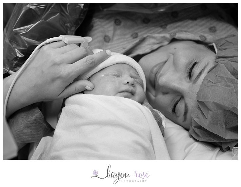 Mom snuggles with baby after birth at Woman's Hospital