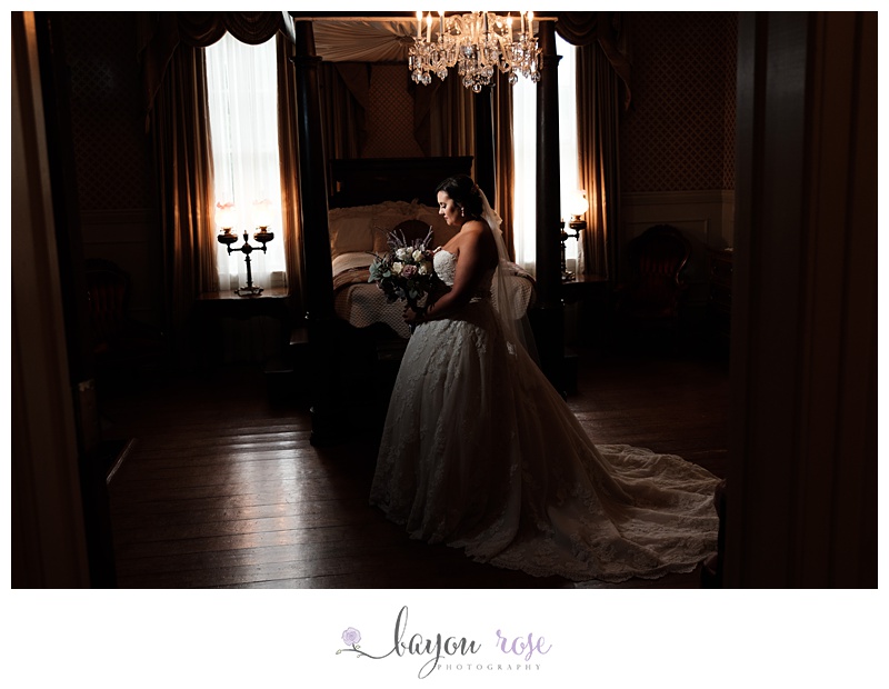 Bride in plantation bedroom under chandelier