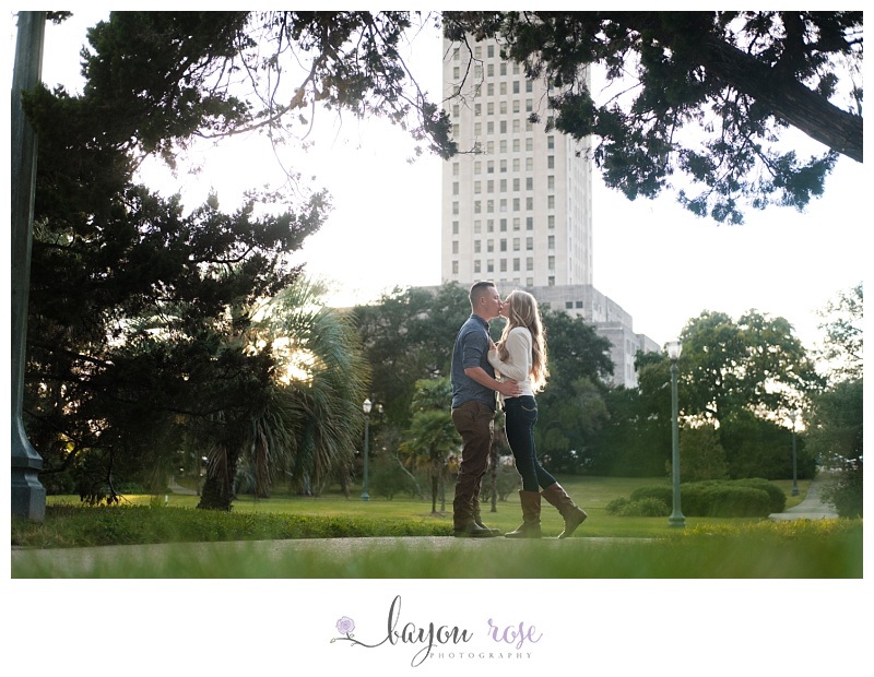 couple kissing with state capitol in the background downtown baton rouge