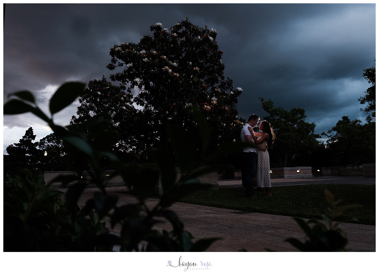 couple silhouetted against storm clouds