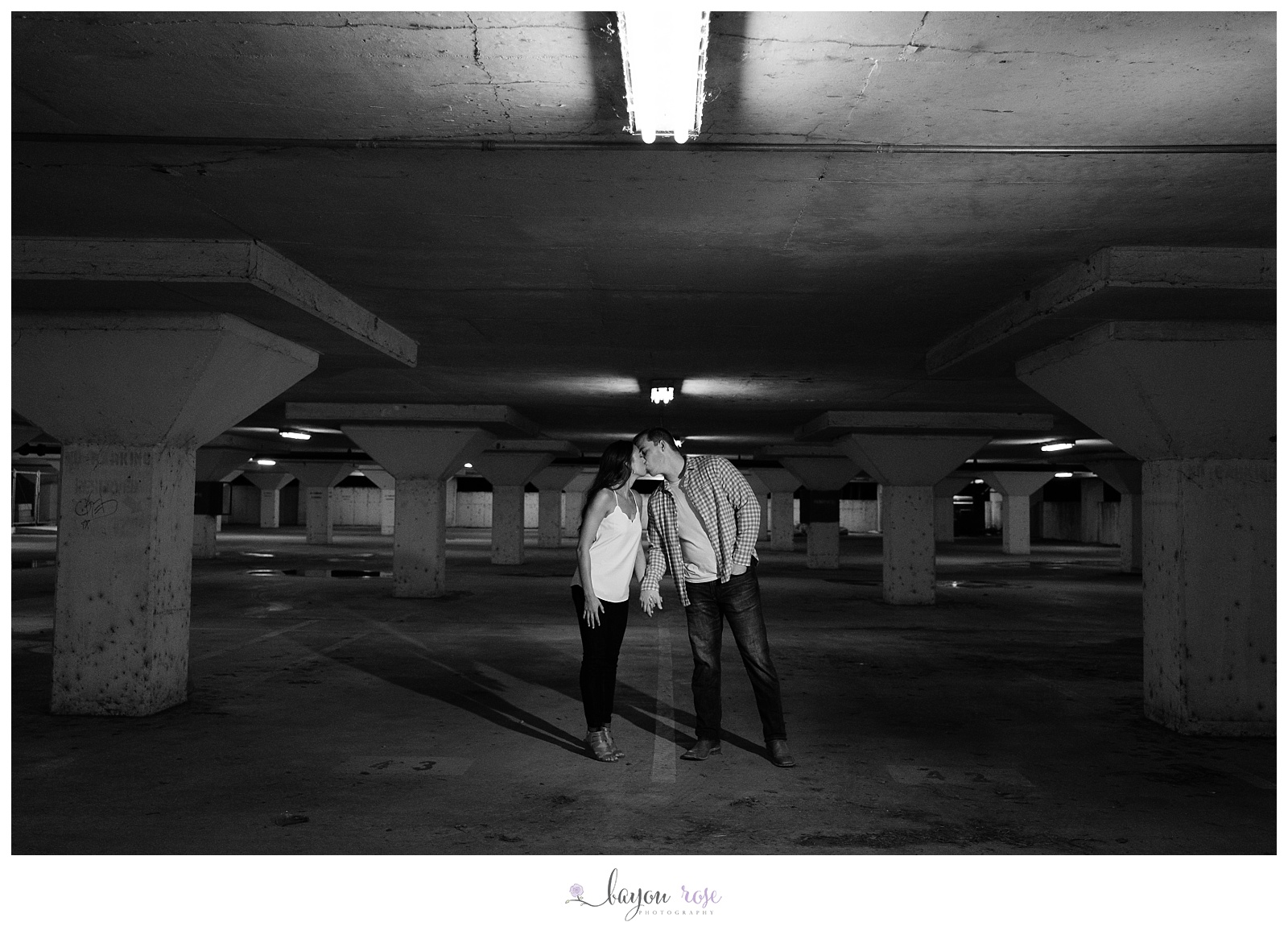 couple kissing in parking garage