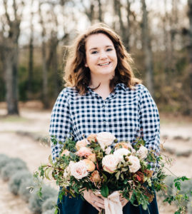 Image of wedding planner holding floral bouquet