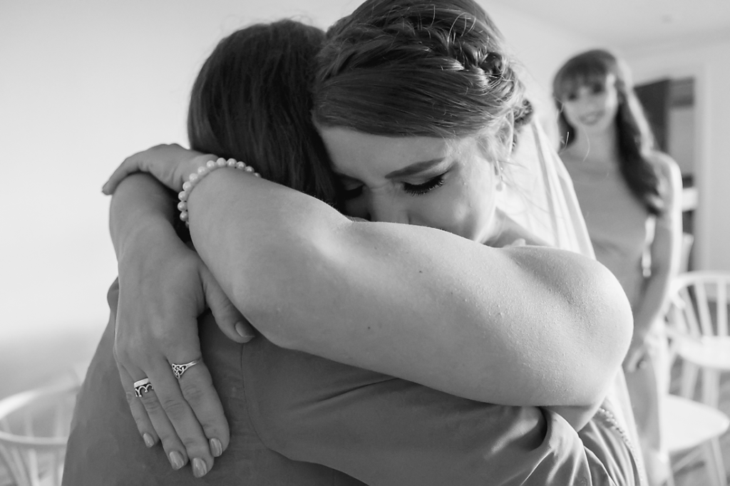 bride cries and hugs mom after mom sees her in her wedding dress