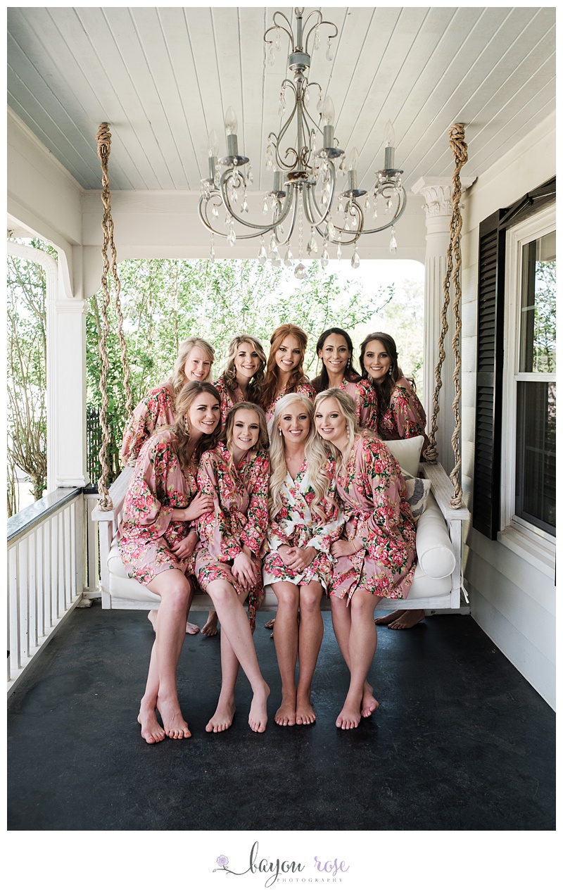 Image of bridesmaids with bride on swing
