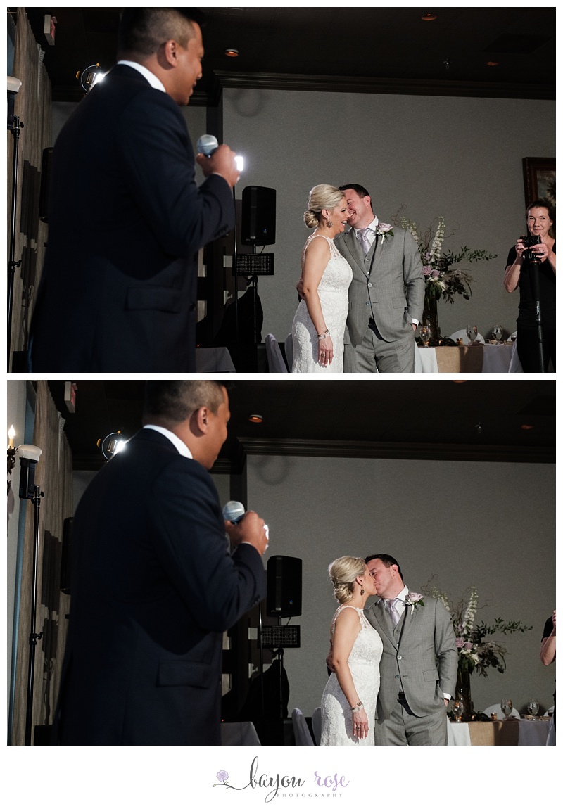 Couple laughing at wedding speech by best man