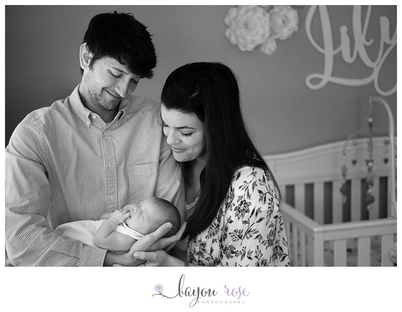 black and white image of family with newborn baby