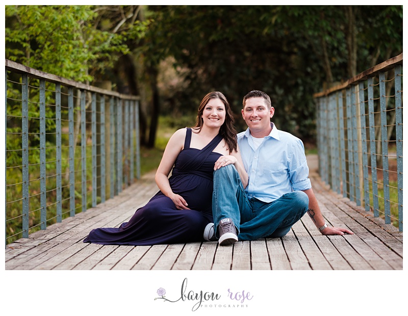 Pregnant woman and husband on bridge at Hilltop Arboretum