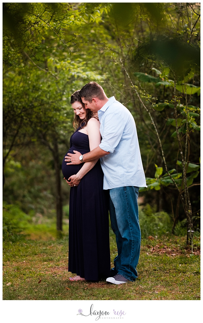 pregnant woman and husband laughing during maternity session