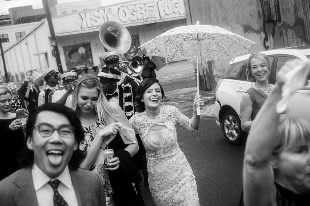 Bride and groom in second line laughing