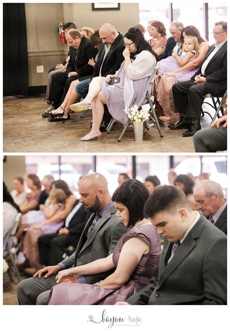 family cries during prayer at ceremony