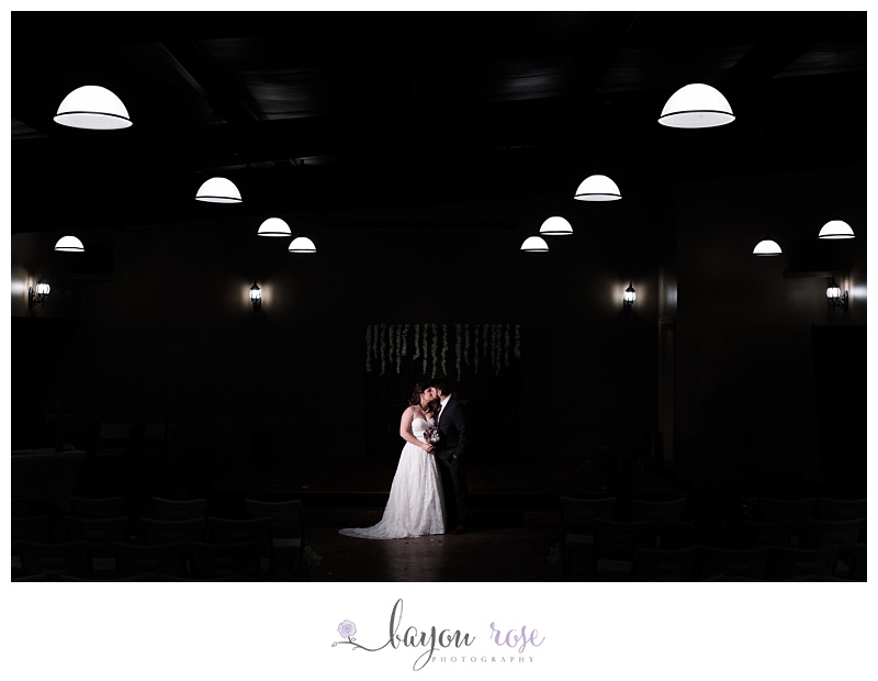 bride and groom under ceremony lights