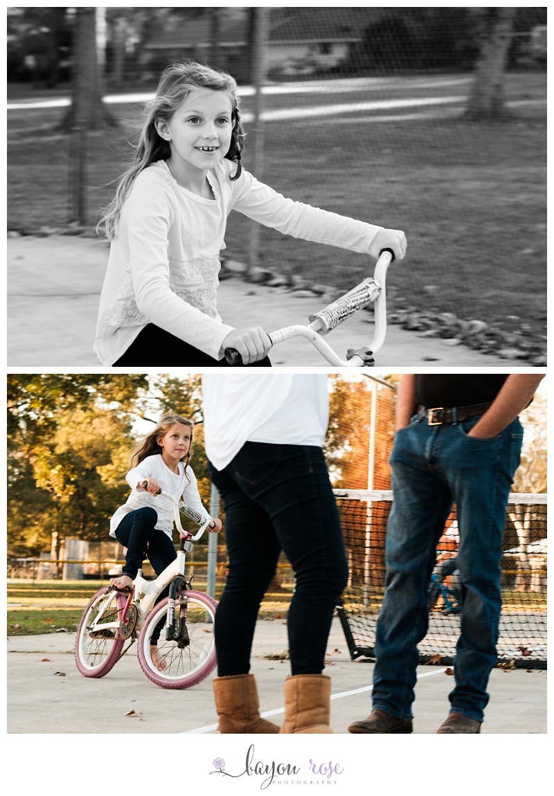 Girl riding bike around parents, motion blurred