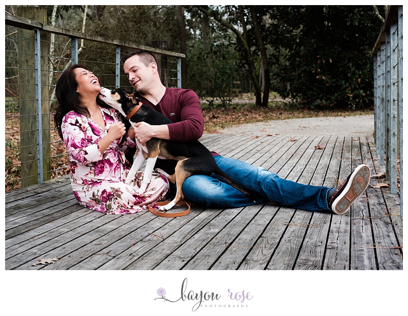 couple posing with dog during their engagement session