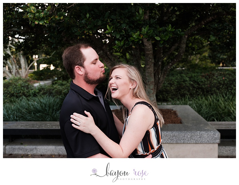 Man makes kissy face at fiancee as she laughs