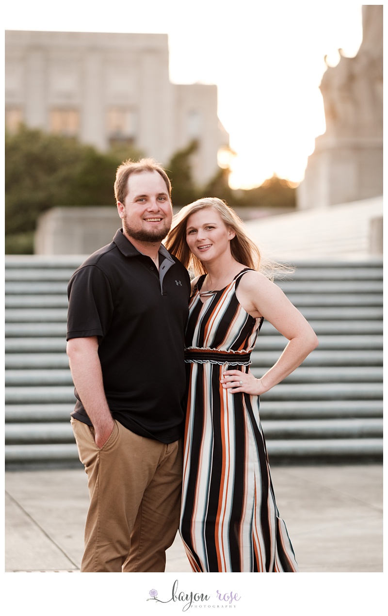 Image of smiling couple at sunset on the steps of the capital building of downtown Baton Rouge