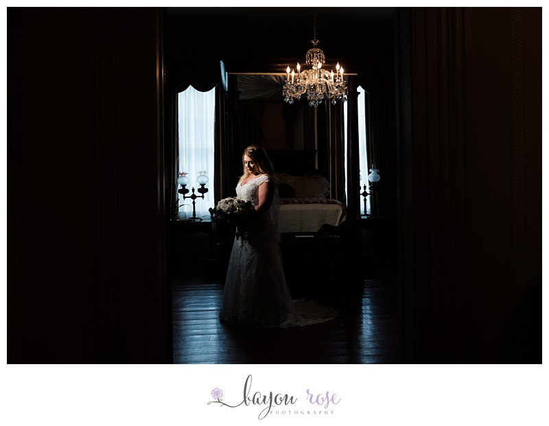Bridal image of woman spotlighted under chandelier