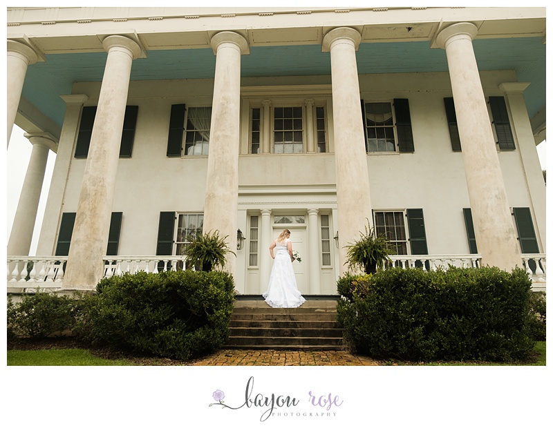 Bride in wedding dress on steps of Greenwood plantation