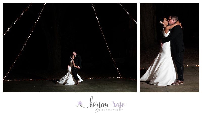 Bride and groom pose for formal photos under fairy lights