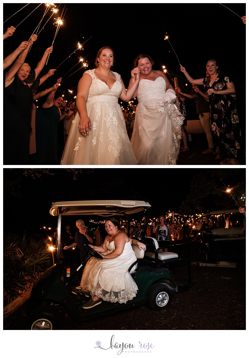brides riding away on golf cart as sparklers are waved