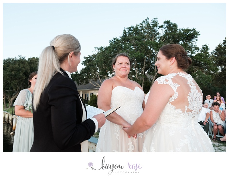 brides sneak looks at one another during wedding ceremony