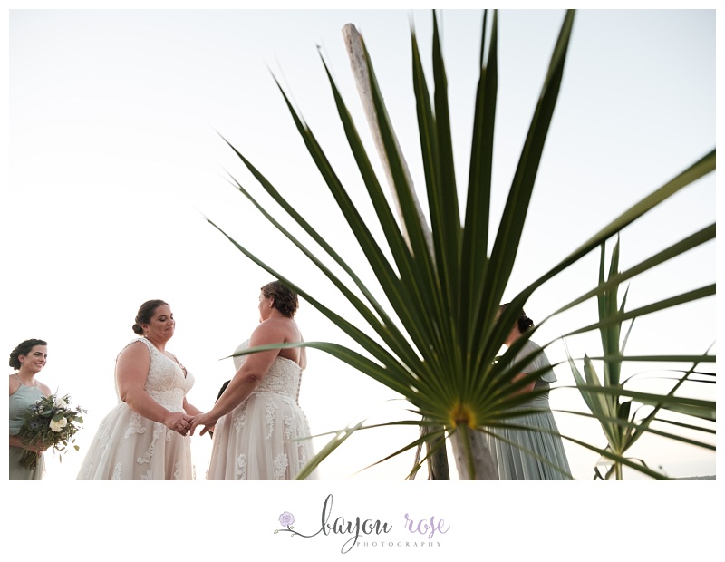 brides photographed against palm fronds