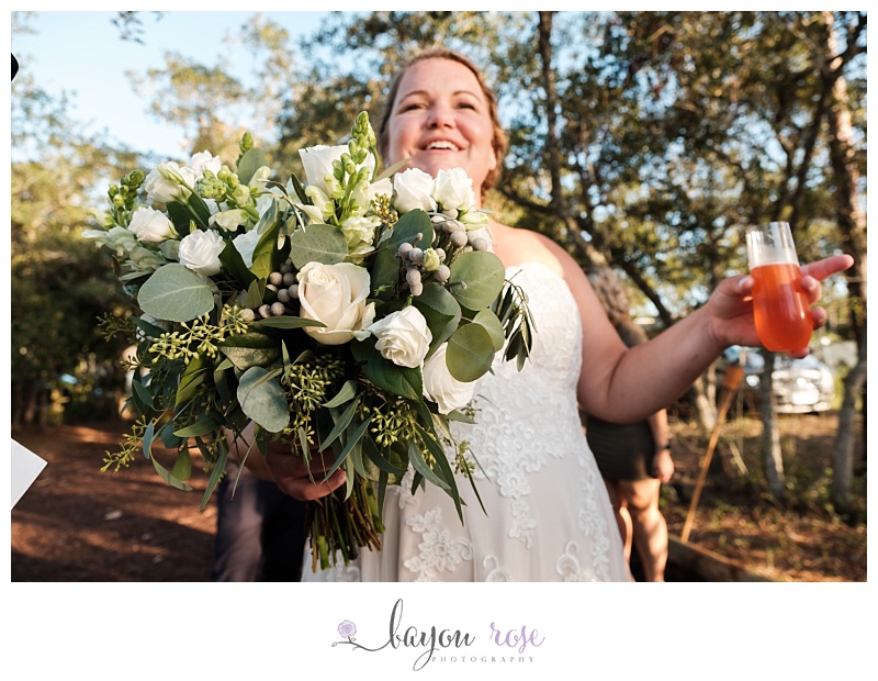 LGBTQ bride holding bouquet and drink