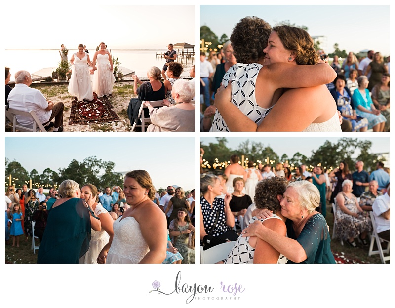mothers of brides hugging each other and crying after ceremony