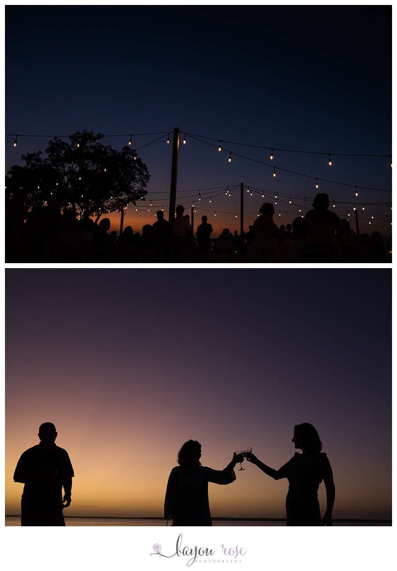 silhouette of guests and string lights at reception at sunset in Pensacola