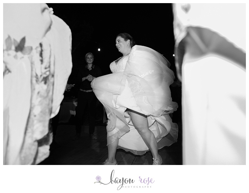 bride running while holding her dress up at the reception