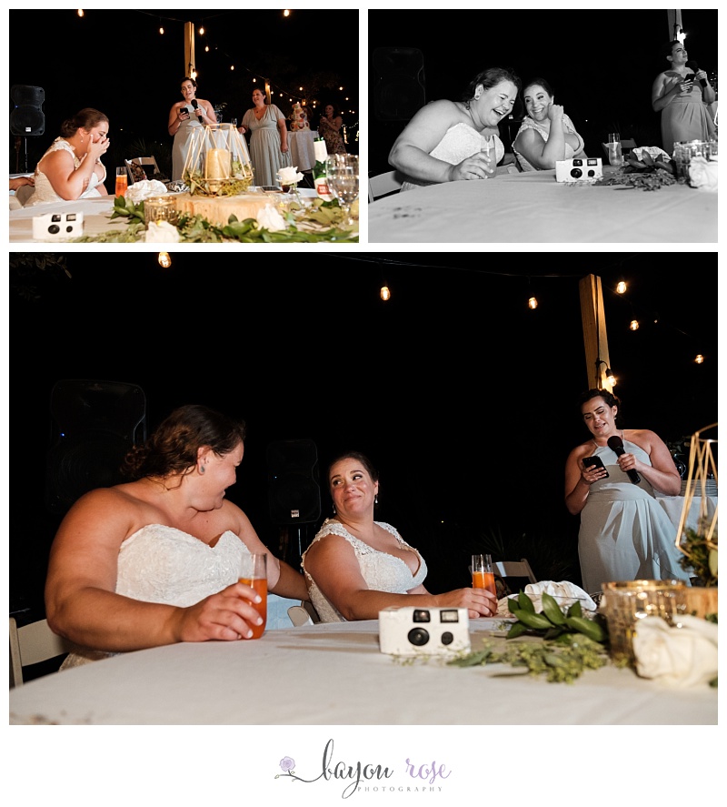 brides laughing as bridesmaid gives toast