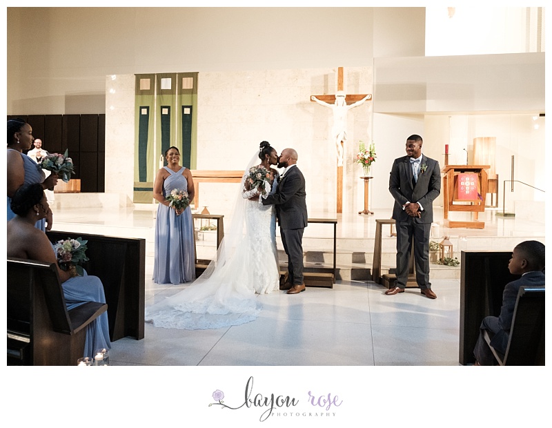bride and groom first kiss at Transfiguration Church New Orleans