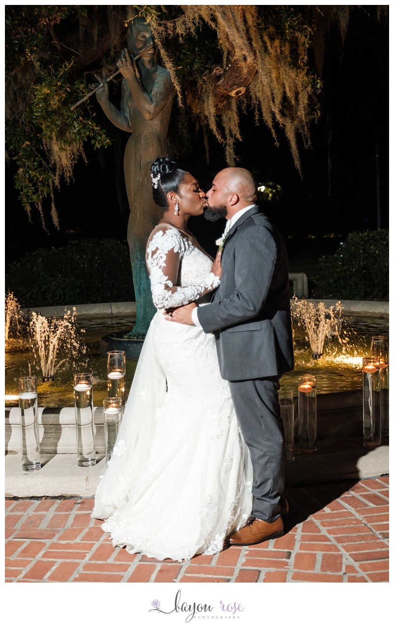 couple kissing by fountain at Pavilion of the Two Sisters New Orleans