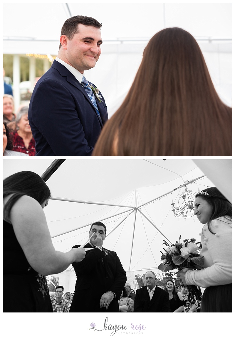 emotional bride and groom during wedding ceremony under tent
