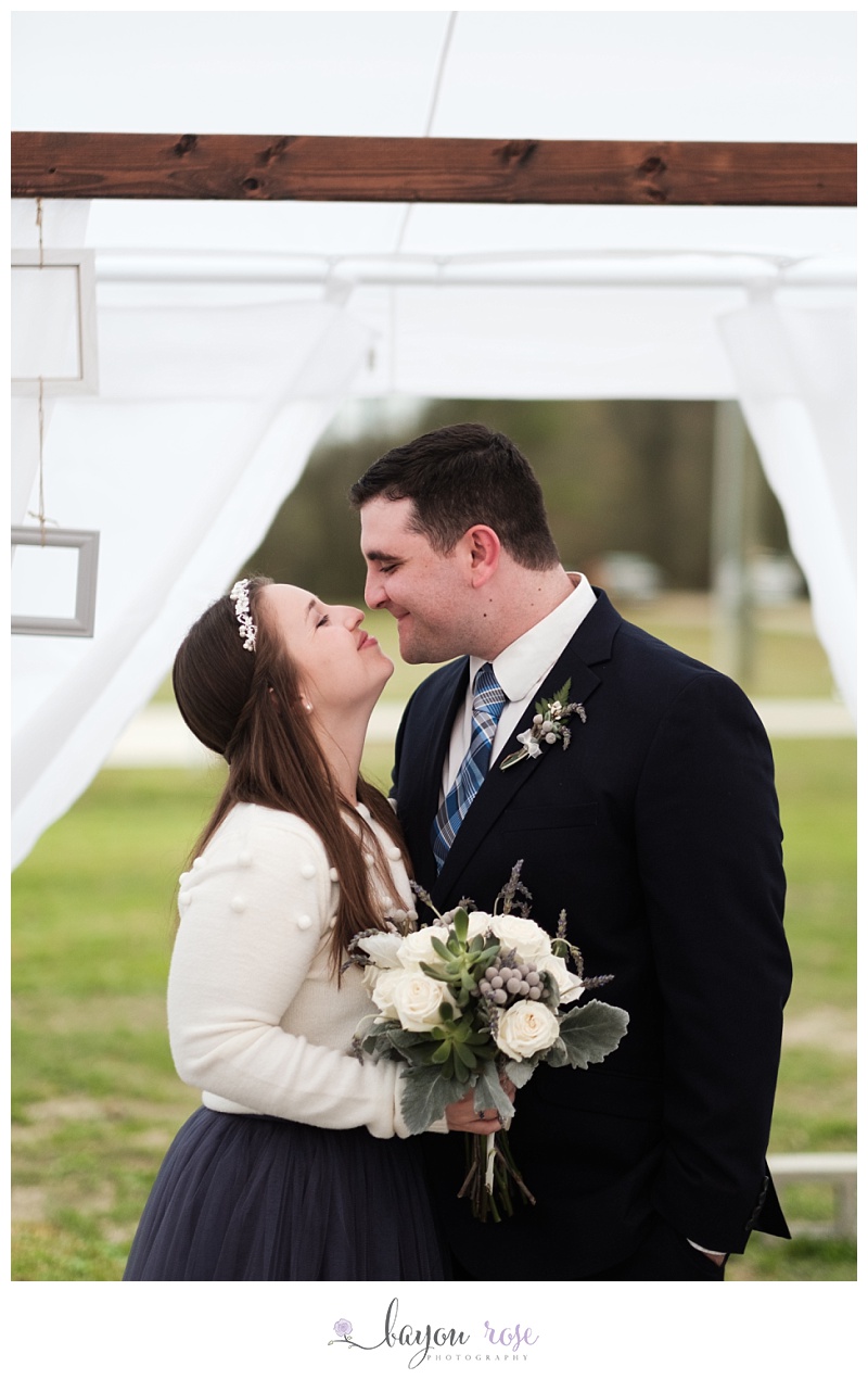 bride and groom nuzzle after intimate wedding ceremony