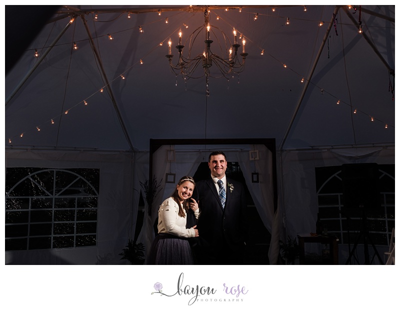 bride and groom portrait under chandelier