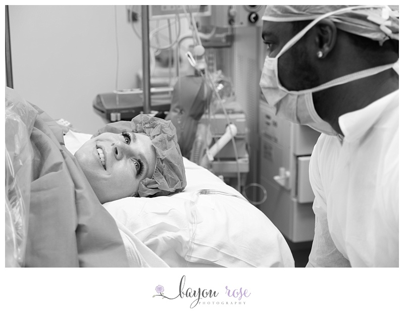 childbirth photography image of mom looking at dad in operating room after c-section