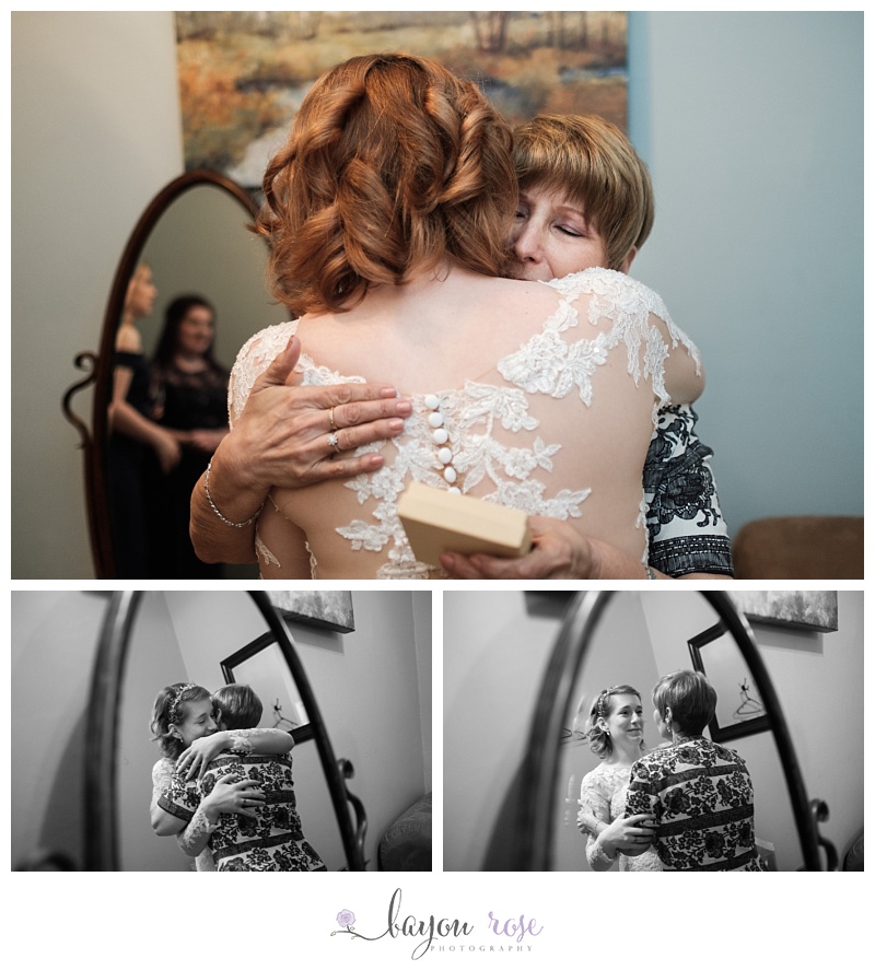 mother of the groom hugs bride in her wedding dress at The Gatehouse
