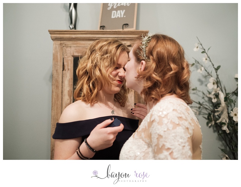 sisters make funny faces together on wedding day