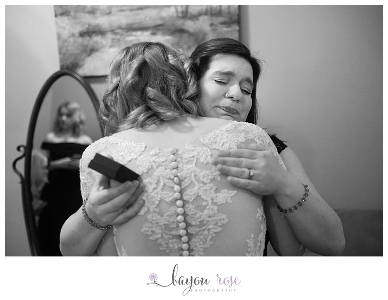 sister of the bride hugs her tight on wedding day at The Gatehouse